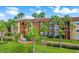 Beautiful two-story building with palm trees and gated entrance at 5578 Metrowest Blvd # 107, Orlando, FL 32811