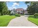 Stunning home with a brick driveway and lush landscaping at 9011 Pinnacle Cir, Windermere, FL 34786