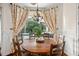 Charming breakfast nook with a round wooden table and pool view at 9011 Pinnacle Cir, Windermere, FL 34786