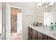 Double vanity bathroom with a large mirror and shower at 9011 Pinnacle Cir, Windermere, FL 34786
