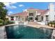 Stunning home exterior with a red tile roof and pool at 9011 Pinnacle Cir, Windermere, FL 34786