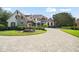 Elegant home exterior with a fountain and paved driveway at 9011 Pinnacle Cir, Windermere, FL 34786