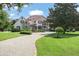 Beautiful home with a circular driveway and manicured lawn at 9011 Pinnacle Cir, Windermere, FL 34786