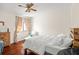 Bedroom with a queen bed, hardwood floors, and natural light at 9011 Pinnacle Cir, Windermere, FL 34786