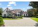 Elegant two-story home with a fountain and circular driveway at 9011 Pinnacle Cir, Windermere, FL 34786