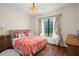 Bright bedroom with floral bedding and large window at 9011 Pinnacle Cir, Windermere, FL 34786