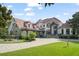 Stunning home exterior with a red tile roof and lush landscaping at 9011 Pinnacle Cir, Windermere, FL 34786