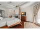 Main bedroom featuring a large bed, fireplace, and access to a balcony at 9011 Pinnacle Cir, Windermere, FL 34786