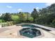 Large, pristine pool with a spa, surrounded by lush landscaping at 9011 Pinnacle Cir, Windermere, FL 34786