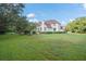 Spacious backyard with lush green lawn and mature trees at 9011 Pinnacle Cir, Windermere, FL 34786