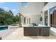 Spacious patio with wicker furniture and adjacent pool and spa at 9011 Pinnacle Cir, Windermere, FL 34786