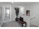 Upstairs hallway with gray carpet, bench, and large mirror at 2754 Flushing Dr, Apopka, FL 32703