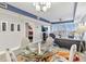 Glass dining table with four chairs, situated near the living room at 13427 Blue Heron Beach Dr # 405, Orlando, FL 32821