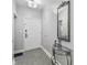 Bright condo entryway with glass-top table and mirror at 13427 Blue Heron Beach Dr # 405, Orlando, FL 32821