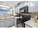 Modern kitchen with gray cabinets and granite countertops at 13427 Blue Heron Beach Dr # 405, Orlando, FL 32821