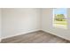 Simple bedroom with large window and wood-look floors at 5277 Sw 165Th Street Rd, Ocala, FL 34473