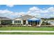 Tan house with blue accents and landscaped yard at 3901 Botancial Court, Sanford, FL 32773