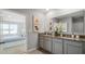 Double vanity bathroom with granite countertop and bedroom view at 3907 Botancial Court, Sanford, FL 32773