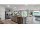 Open concept kitchen with island, stainless steel appliances and view of living area at 3907 Botancial Court, Sanford, FL 32773