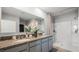 Bathroom with granite countertops, double sinks, and a walk-in shower at 3907 Botancial Court, Sanford, FL 32773