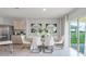 Spacious dining area with modern table and chairs, and access to a patio at 3907 Botancial Court, Sanford, FL 32773