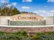 Community entrance with a beautiful water feature and signage at 3907 Botancial Court, Sanford, FL 32773