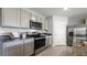 Modern kitchen with stainless steel appliances and granite countertops at 3907 Botancial Court, Sanford, FL 32773