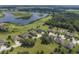 Community overview showcasing homes near a lake and golf course at 31944 Geoff Way, Sorrento, FL 32776