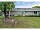 Backyard view of the house showing landscaping and lawn at 701 Castlewood Dr, Winter Springs, FL 32708