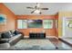 Relaxing living room with sectional sofa and orange walls at 701 Castlewood Dr, Winter Springs, FL 32708