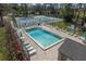 Community pool with lounge chairs, tennis courts, and a small shed at 701 Castlewood Dr, Winter Springs, FL 32708