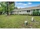 View of the house from the backyard, showing landscaping and lawn at 701 Castlewood Dr, Winter Springs, FL 32708