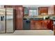 Modern kitchen with stainless steel appliances and dark wood cabinets at 701 Castlewood Dr, Winter Springs, FL 32708