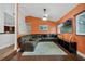 Relaxing living room with sectional sofa and orange walls at 701 Castlewood Dr, Winter Springs, FL 32708