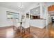 Bright dining room with glass table and white chairs at 701 Castlewood Dr, Winter Springs, FL 32708
