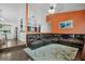 Relaxing living room with sectional sofa and orange walls at 701 Castlewood Dr, Winter Springs, FL 32708