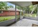 Peaceful screened porch with tiled floor and views of backyard and neighboring house at 701 Castlewood Dr, Winter Springs, FL 32708