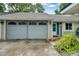 Grey garage with screen door and spacious driveway at 701 Castlewood Dr, Winter Springs, FL 32708