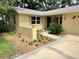 House exterior showcasing a landscaped yard, light beige color, and a two-car garage at 425 E Hillcrest St, Altamonte Springs, FL 32701