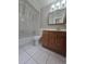 Bathroom with bathtub, toilet and wooden vanity at 425 E Hillcrest St, Altamonte Springs, FL 32701