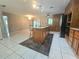 Kitchen with wood cabinets, granite countertops, and an island with seating at 425 E Hillcrest St, Altamonte Springs, FL 32701