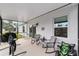 Cozy screened patio with rocking chairs and outdoor seating at 781 Marion Oaks Trl, Ocala, FL 34473