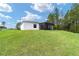Landscaped backyard with a screened patio and ample space at 781 Marion Oaks Trl, Ocala, FL 34473