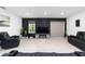 Living room with black reclining sofas and a fireplace at 781 Marion Oaks Trl, Ocala, FL 34473