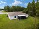 House with backyard screened porch and grassy yard in a residential area at 781 Marion Oaks Trl, Ocala, FL 34473