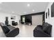 Spacious living room with black leather furniture at 781 Marion Oaks Trl, Ocala, FL 34473