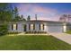 One-story home with two-car garage at dusk at 781 Marion Oaks Trl, Ocala, FL 34473