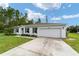 Single-story house with a two-car garage and well-maintained lawn at 781 Marion Oaks Trl, Ocala, FL 34473