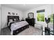 Bedroom with a black platform bed, dresser, and carpet flooring at 781 Marion Oaks Trl, Ocala, FL 34473