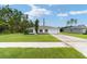 Single-story house with a two-car garage and well-manicured lawn at 781 Marion Oaks Trl, Ocala, FL 34473